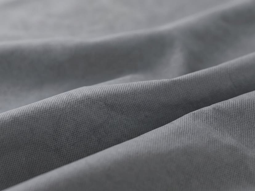Illustrated close-up of grey polypropylene cover fabric in soft folds.