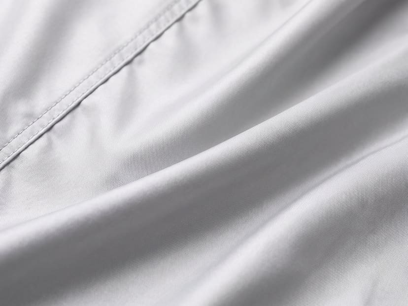 Illustrated close-up of silver polyester cover fabric in soft folds.