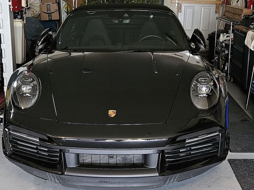 Steve's black Porsche 911 Turbo uncovered in his garage, seen from the front