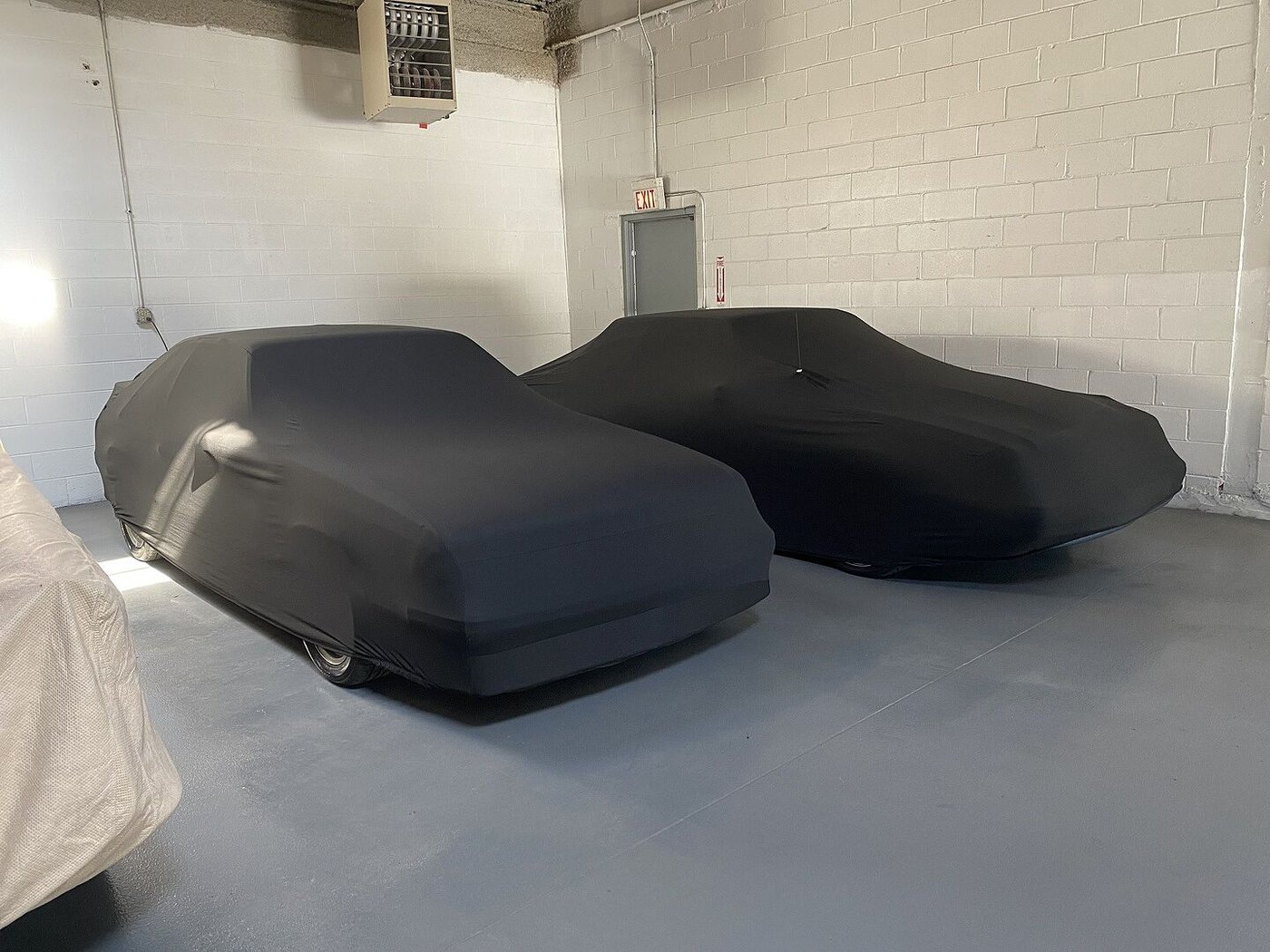 A customer's garage-kept car under its CarCovers cover