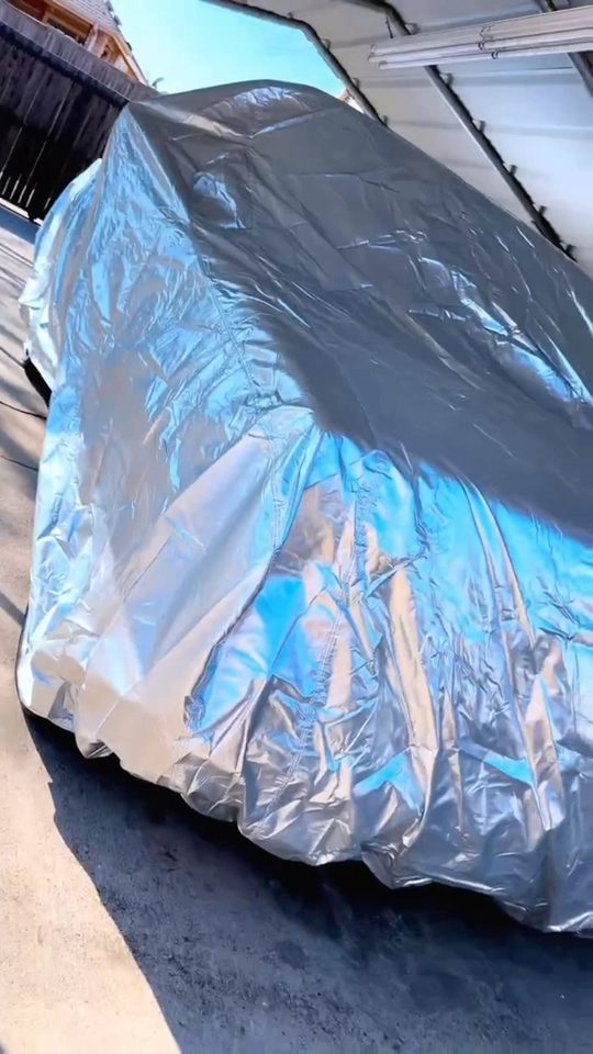 Silver Platinum cover fully on a dropped Chevy truck in strong sun
